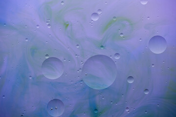 Current collection of brilliant backgrounds for your design. Close-up shot of water spots and bubbles on painted in blue, violet and green surface.