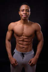Fototapeta na wymiar Portrait of young handsome muscular African man shirtless