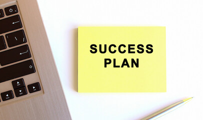 The inscription on the yellow sticky notes near to the laptop on the white office desk. Business concept.