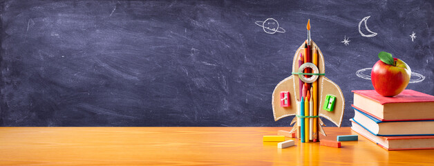 Startup Concept - Creative Rocket With Colorful Pencils And Books On Desk - Back To School
