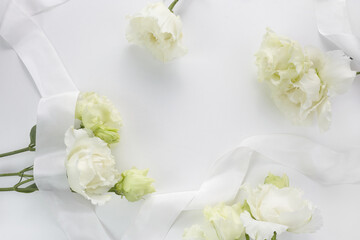 Fototapeta na wymiar Eustoma flowers background in flat style on white background. Holiday composition. Wedding fashion
