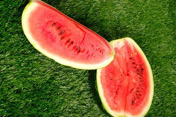 slices of cut watermelon ,juicy watermelon on green grass, summer time