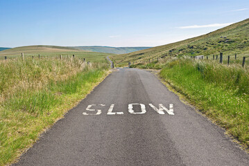 Warning sign telling traffic to slow down when approaching a hazard on a lonely moorland road in the Sperrin mountains of County Londonderry, Northern Ireland.