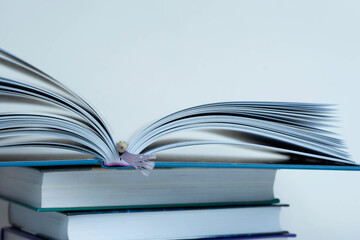 A stack of books on a white background. Open book.