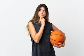 Young woman playing basketball isolated on white background having doubts and thinking