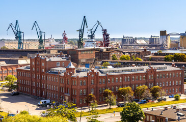 Panoramic view of Gdansk Shipyard industrial infrastructure with shipyard directorate main historic building in Gdansk, Poland