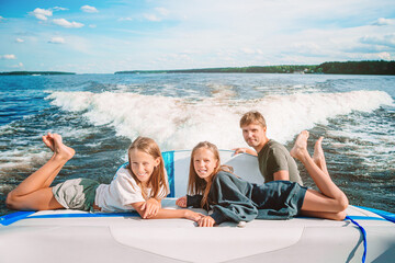 Family sailing on boat in clear open sea