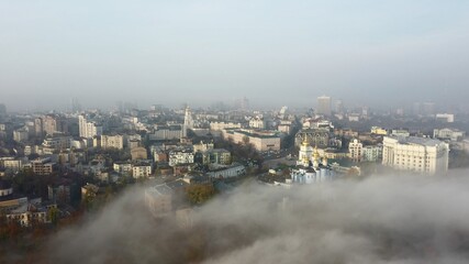 Fototapeta na wymiar Aerial view of the city in the fog.