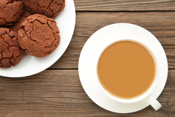Cup of coffee and chocolate cookies on grey wooden table