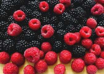 Appetizing background of fresh raspberries and blackberries