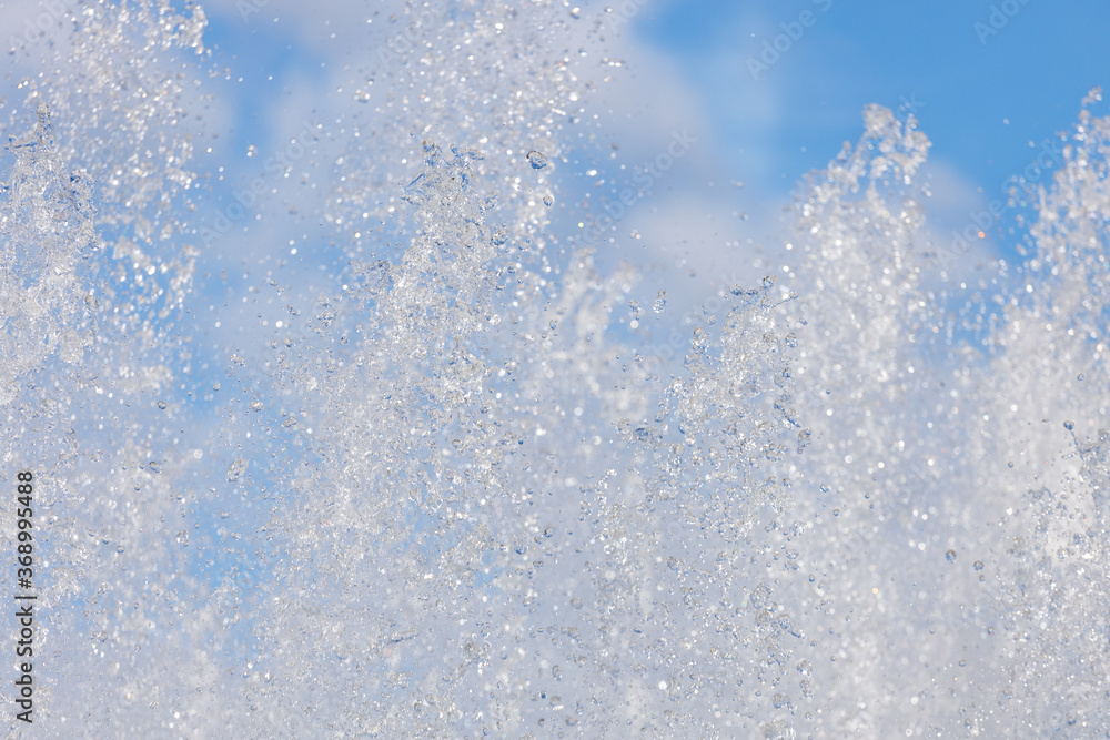 Poster jets with splashing water on the background of the sky with clouds