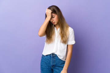 Young woman over isolated purple background with headache