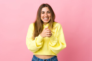 Young woman over isolated pink background laughing