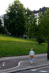 Fototapeta na wymiar Person walking close to a park