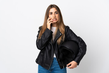 Young Woman holding a motorcycle helmet over isolated white background nervous and scared