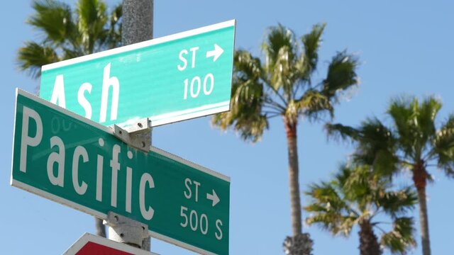Pacific street road sign on crossroad, route 101 tourist destination, California, USA. Lettering on intersection signpost, symbol of summertime travel and vacations.Signboard in city near Los Angeles.
