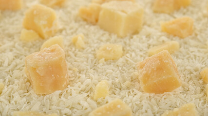 Fototapeta na wymiar hard cheese parmesan grated and pieces close up
