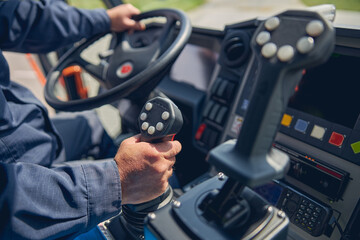 Fototapeta premium Man putting hands on the handlebars of machine