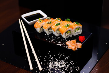 Sushi with salmon. Soy sauce, ginger, red caviar. Roles with red fish.
