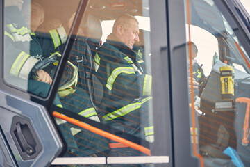 Firefighters sitting in the fire modern machine