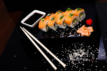 Sushi with salmon. Soy sauce, ginger, red caviar. Roles with red fish.