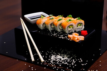 Sushi with salmon. Soy sauce, ginger, red caviar. Roles with red fish.