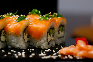Sushi with salmon. Soy sauce, ginger, red caviar. Roles with red fish.
