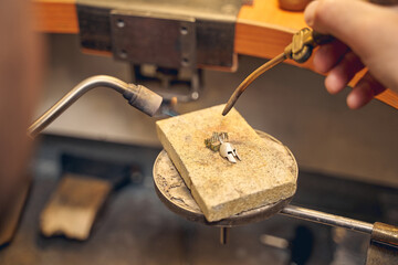 Professional jeweler treating a stainless steel workpiece