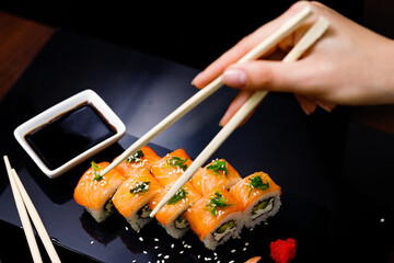Sushi with salmon. Soy sauce, ginger, red caviar. Roles with red fish.