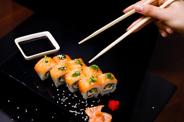 Sushi with salmon. Soy sauce, ginger, red caviar. Roles with red fish.