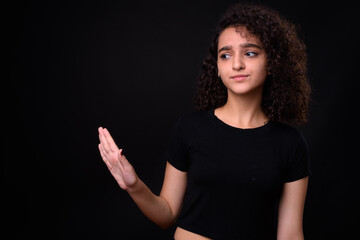 Portrait of young beautiful Persian teenage girl with curly hair