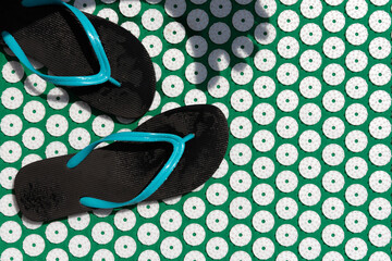 Massage mat for acupuncture and swimming pool flip- flops.