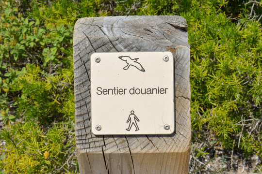 Trail sign on the Sentier des Douaniers (Custom Officers Route), a famous coastal path for hikers, Corsica, France