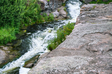 mountain stream waterfall and green moss on the stone