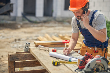Man in overalls talking on the phone