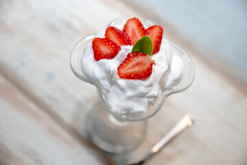 strawberries with cream in a glass bowl