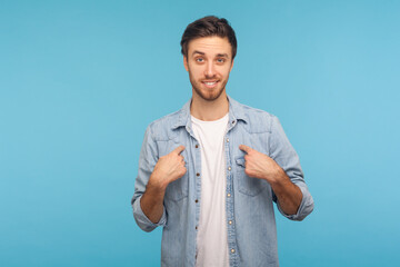 This is me! Portrait of self-confident narcissistic man in worker denim shirt smiling satisfied and...