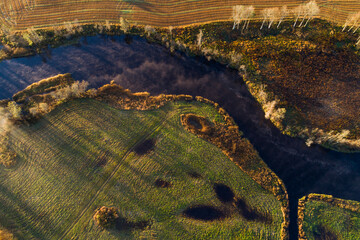 An aerial of a smaller river flowing into a bigger, Pärnu river in Estonia, Northern Europe.
