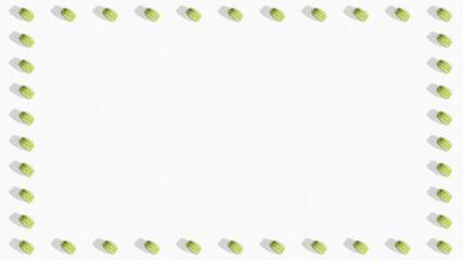 Thirty-eight mint or pistachio macarons placed forming a frame on a white soft striped background, with copy space.