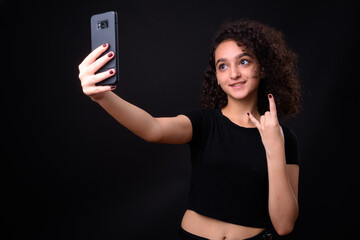 Portrait of young beautiful Persian teenage girl with curly hair