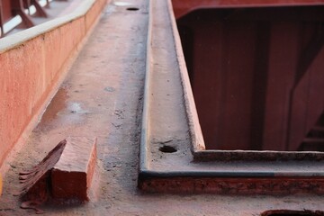 Top of the cargo hold hatch coaming with view of drainage channel and hole