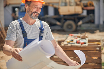 Smiling man looking at a house plan