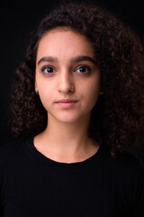 Portrait of young beautiful Persian teenage girl with curly hair