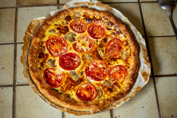 homemade quiche with mushrooms and tomato, french food, top view