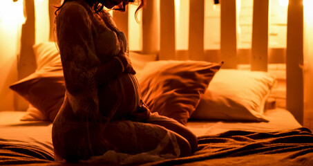 A pregnant woman feels happy taking care of her baby. Young expectant mother holding belly with...