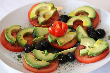 Tomato and avocado salad with olives