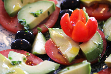 Tomato and avocado salad with olives