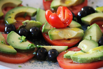 Tomato and avocado salad with olives