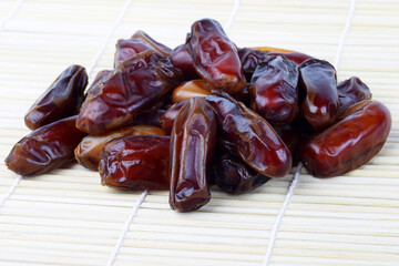 Pile of sweet Dates on a light bamboo napkin