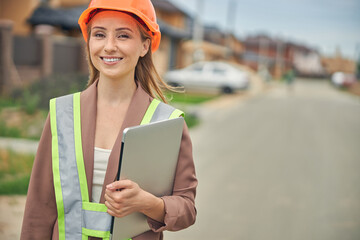 Woman with a computer posing for the camera